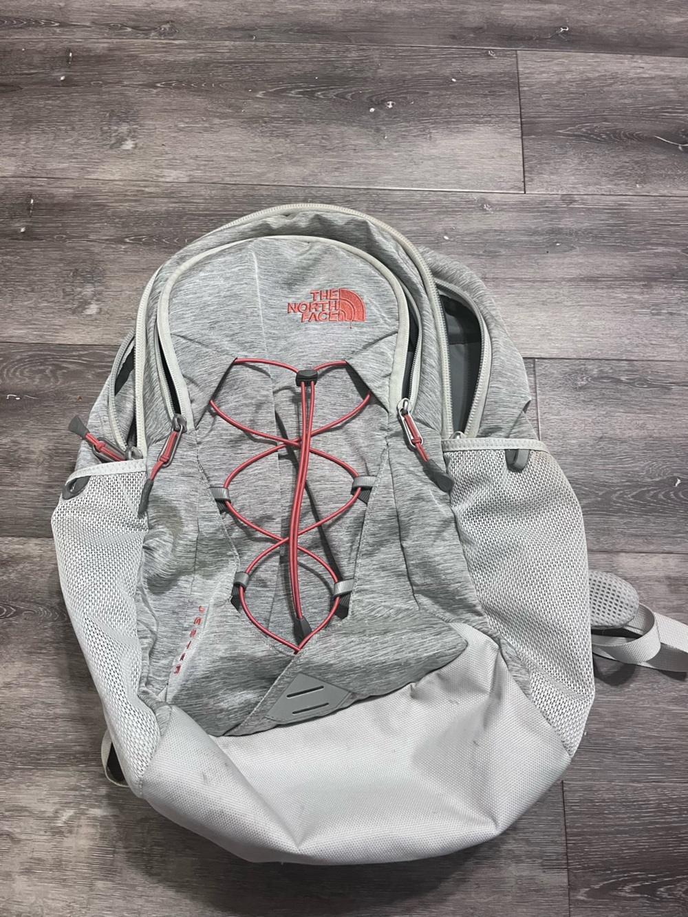 The North Face light gray backpack with pink accents